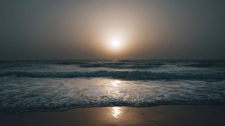 Experience the calming beauty of a sunset over the ocean, where gentle waves meet a golden horizon under a moody sky. Ideal for relaxation.の素材