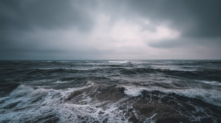 This image showcases a dramatic seascape with turbulent waves under a moody sky filled with dark clouds, reflecting nature's raw power.の素材