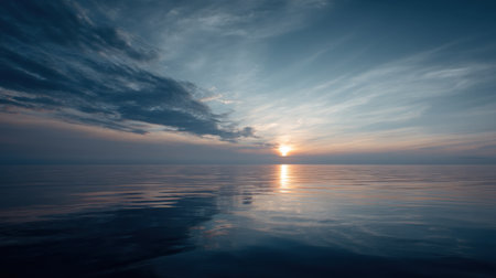 Experience the serene beauty of a twilight ocean scene, where gentle waves meet a tranquil sky filled with soft clouds at dusk.の素材