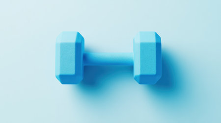 This light blue dumbbell rests on a soft pastel background, symbolizing fitness and healthy lifestyle. Perfect for showcasing exercise routines or gym-related themes.の素材