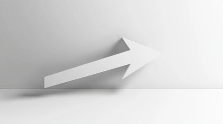 A clean and minimalist image of a white arrow pointing upwards against a simple white wall, perfect for use in modern design projects, backgrounds, and graphics.の素材