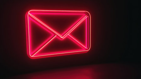 A striking neon email icon in bright pink glows against a dark background, perfect for modern digital communication themes and branding visuals.の素材