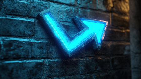 A neon arrow sign, glowing in vibrant blue, stands out against a textured brick wall, conveying direction and modern energy in a dark space.の素材