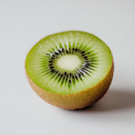 A vibrant green kiwi fruit slice showcasing its unique texture and rich color, perfect for promoting healthy eating and fresh culinary delights.の素材