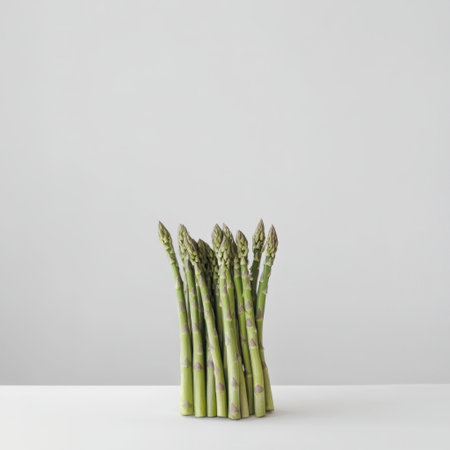 Fresh green asparagus stalks create a stunning visual on a minimalist white background, highlighting the beauty of healthy ingredients and clean eating.の素材