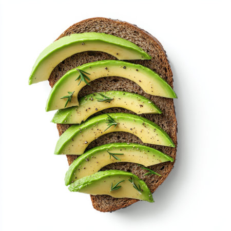 Freshly sliced avocado arranged on whole grain toast, garnished with herbs and black pepper. Perfect for a nutritious, aesthetically pleasing meal choice.の素材