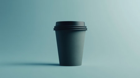 A sleek, modern coffee cup set against a soft blue backdrop, ideal for themes of relaxation and minimalist design in beverage promotion.の素材