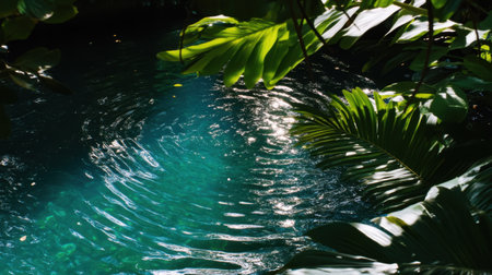 A serene view of a tranquil water surface featuring gentle ripples and reflections, surrounded by vibrant green leaves in a lush setting.の素材
