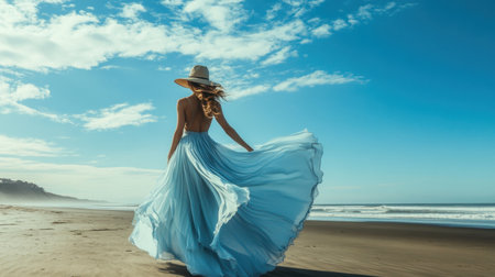 A graceful woman in a blue flowing dress stands on the beach, enjoying a picturesque day. Sunlight sparkles on gentle waves, creating a serene scene.の素材