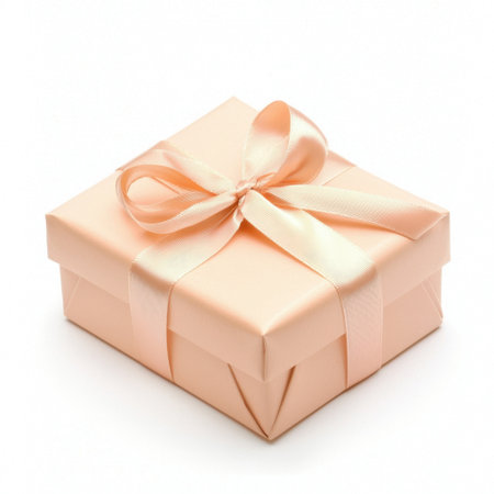 A beautifully wrapped soft peach gift box adorned with a satin ribbon, perfect for special occasions, celebrations, or surprise gifts.の素材