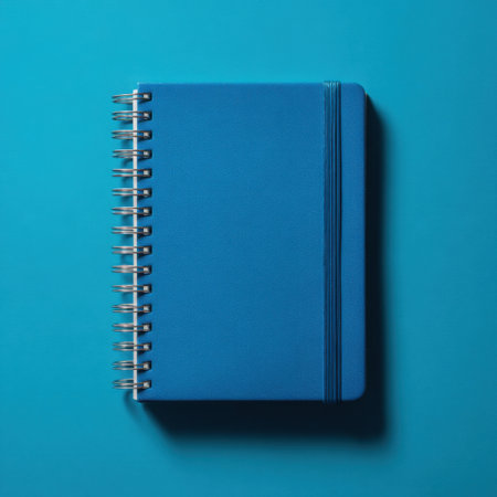 A sleek blue spiral notebook lies flat against a vibrant background, perfect for jotting down thoughts, organizing ideas, or doodling creatively.の素材
