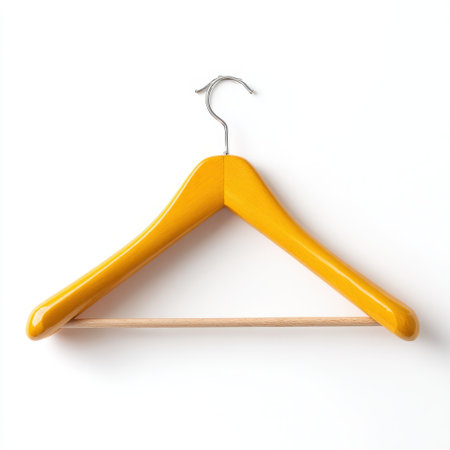 A bright yellow wooden hanger stands out against a clean white backdrop, showcasing modern design ideal for retail displays and interior styling.の素材