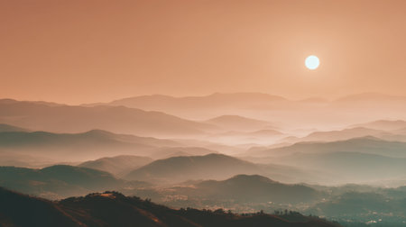 A breathtaking view of a serene sunset illuminating misty mountains. The warm hues create a tranquil atmosphere, inviting relaxation and reflection.の素材