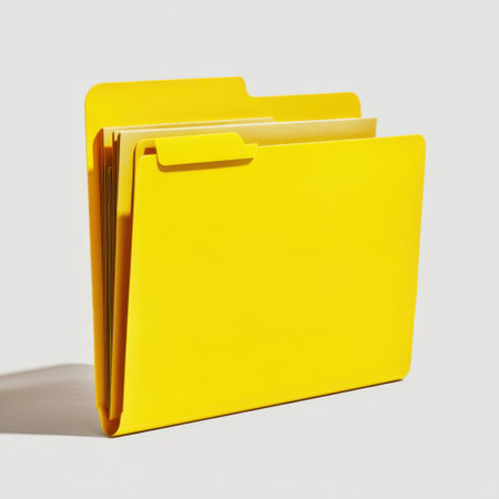 A bright yellow folder stands prominently against a light backdrop, representing organization and creativity in various workspaces. Ideal for showcasing office supplies, this image highlights simplicity and function.の素材