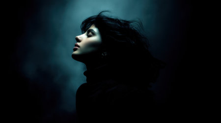 A captivating profile portrait of a woman surrounded by a misty dark atmosphere, illuminated by soft light, creating a serene and artistic mood.の素材