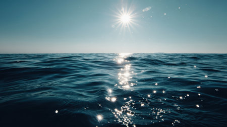 A picturesque view of calm ocean waves glistening under bright sunlight, creating a serene atmosphere that invites relaxation and tranquility.の素材