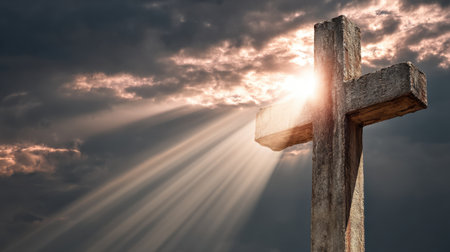 A striking image of a wooden cross bathed in light, with rays of sunshine breaking through dramatic clouds, evoking themes of faith and spirituality.の素材