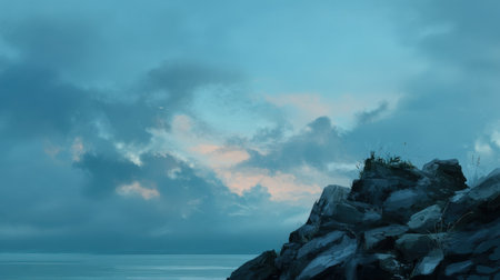 This serene coastal landscape captures a rocky shoreline under a dramatic sky filled with clouds at dusk. The tranquil scene invites reflection and exploration of nature's beauty.の素材