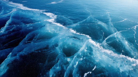 Experience a stunning aerial view showcasing crystalline ocean waves in vibrant blue water, enhanced by gentle foam trails under a bright sky.の素材