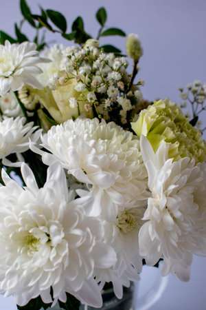 bouquet of white flowers in a vase, close-up photo on a white background, chrysanthemums, gerberas, gypsophilaの写真素材