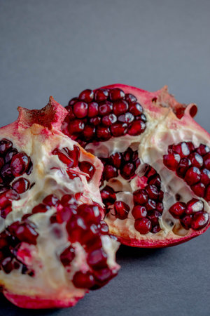 Red juicy pomegranate on a dark background, close-up.の写真素材