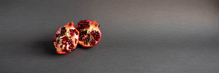 red pomegranate on a panoramic dark backgroundの写真素材