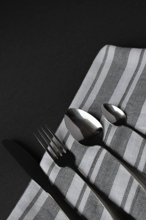 tableware with a napkin on a dark backgroundの写真素材
