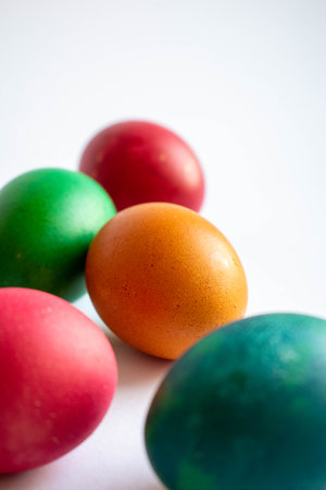 Multicoloured handmade Easter egg on a white background