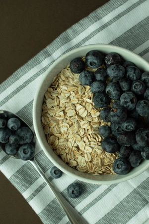 A healthy and wholesome breakfast, oatmeal with blueberries in the background