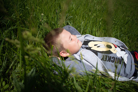A happy child lying on the grass