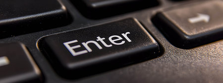 A close-up of the computer's Enter key.の素材