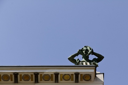 An art nouveau building with a screaming sculpture on top in Viennaの写真素材