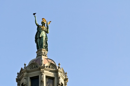 A greek goddess on the top of a historical building of Viennaの写真素材