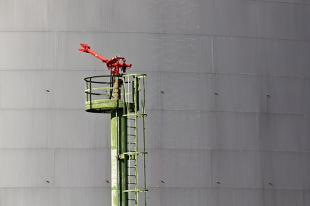 A fire extinguisher on an industrial area where oil and gas is storedの写真素材