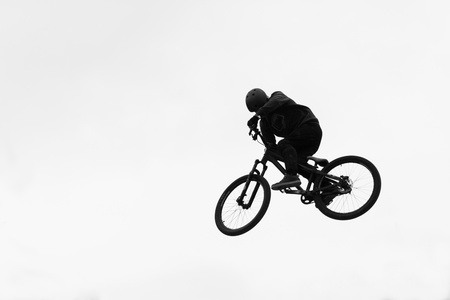 A bike stunt jump in the airの写真素材
