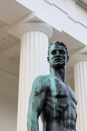A statue of a hero in front of Vienna's theseus templeの写真素材
