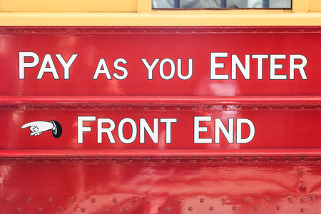 Text on an old touristic tram in Christchurch, New Zealand: pay as you enter - front endの写真素材