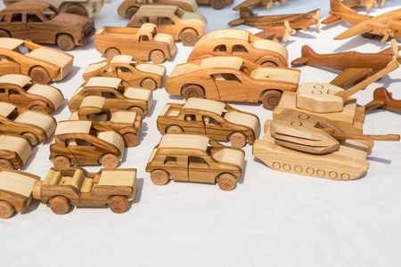 a selection of wooden toy cars, tanks and planesの写真素材