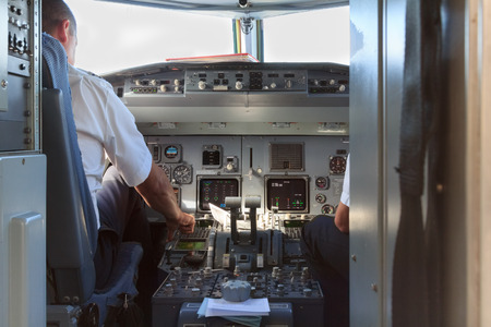 A view into a an airplane cockpit with pilots after landingの写真素材