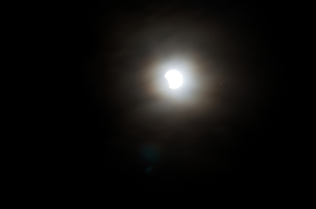April 14, 2014 (4/14/2014) - Beginning Of Total Lunar Eclipse Behind Cloudsのeditorial素材