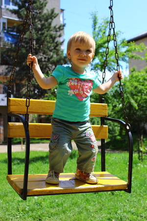 Baby is playing in a swingの写真素材