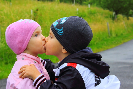 brother kisses a kid sisterの写真素材