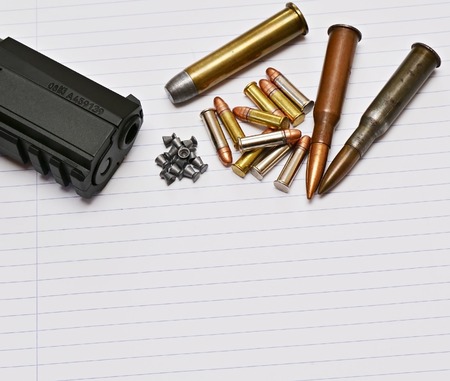 Detail of gun and ammunition, handgun and mix of bulletsの写真素材