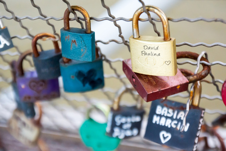 Love padlocks on fence hanging on bridge in Krakow, Poland