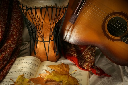 Drum and guitar with notes and yellow  autumn leavesの写真素材