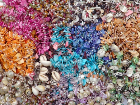 Background of colorful beads with seashellsの写真素材