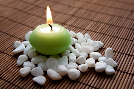 Composition with white  stones and flaming candle, symbolizing  calmness, inner harmony  and meditationの写真素材