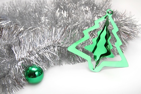 Christmas background with silver tinsel, green sphere and stylish cristmas tree decorationの写真素材