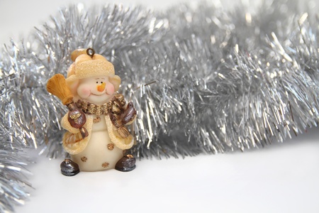 Christmas background with cheerful toy snowman and silver Christmas tinsel. Horizontalの写真素材