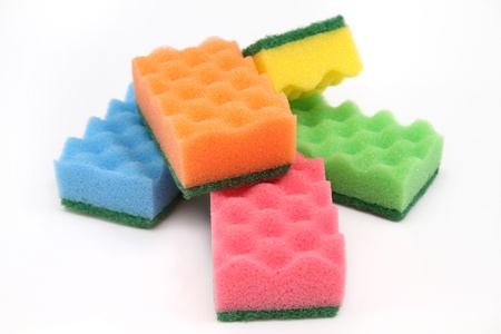 Group of bright-colored  sponges for cleaning and home care - isolated on white background